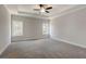 Spacious main bedroom featuring plush carpet, tray ceiling with fan, and bright natural light from two windows at 3298 Rangers Gate, Marietta, GA 30062