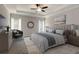 The main bedroom features a tray ceiling, ceiling fan, plush carpet and two windows at 3298 Rangers Gate, Marietta, GA 30062
