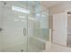 Large, tiled shower with a glass enclosure, a built-in bench, and a showerhead, bathed in natural light at 3298 Rangers Gate, Marietta, GA 30062