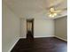 Bright bedroom with neutral walls, ceiling fan, and dark hardwood floors at 79 Dogwood Ferry Ct, Lawrenceville, GA 30046
