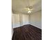 Bedroom with white walls, dark hardwood floors, and a double-door closet at 79 Dogwood Ferry Ct, Lawrenceville, GA 30046