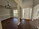 Spacious dining room featuring hardwood floors, large windows, modern lighting and neutral paint at 79 Dogwood Ferry Ct, Lawrenceville, GA 30046