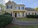 Charming two-story home with a covered front porch, well-manicured bushes, and a lovely walkway at 79 Dogwood Ferry Ct, Lawrenceville, GA 30046