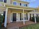 Inviting front porch with brick detail, white columns, and a classic black front door and black shutters at 79 Dogwood Ferry Ct, Lawrenceville, GA 30046