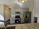 Modern kitchen with granite countertops, stainless steel appliances, gray cabinets and black tile flooring at 79 Dogwood Ferry Ct, Lawrenceville, GA 30046