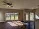 Bright living room with large windows, natural light, ceiling fan and views of the backyard at 79 Dogwood Ferry Ct, Lawrenceville, GA 30046
