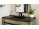 Stylish bathroom with dark vanity, modern sink, and decorative details at 1031 Camilla Sw St, Atlanta, GA 30314