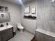 Elegant bathroom featuring tiled walls, a modern vanity, and stylish fixtures at 1031 Camilla Sw St, Atlanta, GA 30314