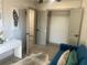 Bright bedroom space with open closet, desk, and blue couch at 1031 Camilla Sw St, Atlanta, GA 30314