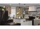 Stylish kitchen with stainless steel refrigerator, an island, and sleek black pendant lighting at 1031 Camilla Sw St, Atlanta, GA 30314