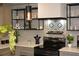 Modern kitchen featuring sleek black appliances, custom tile backsplash, and open shelving at 1031 Camilla Sw St, Atlanta, GA 30314