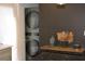 Convenient laundry area featuring a stackable washer and dryer unit with a modern accent table at 1031 Camilla Sw St, Atlanta, GA 30314