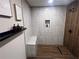 Luxurious shower with floor-to-ceiling tile, a built-in bench, and a sleek showerhead at 1031 Camilla Sw St, Atlanta, GA 30314