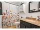 Full bathroom featuring granite counters, a large mirror, and a modern floral shower curtain at 210 Woodcliff Dr, Atlanta, GA 30350