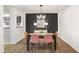 Contemporary dining room accented by black feature wall and stylish lighting at 210 Woodcliff Dr, Atlanta, GA 30350