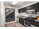 Efficient kitchen features dark cabinets, stainless steel appliances, and views of backyard at 210 Woodcliff Dr, Atlanta, GA 30350