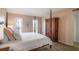 Spacious main bedroom with a four poster bed, wood floors, and natural light from large windows at 210 Woodcliff Dr, Atlanta, GA 30350