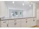 Kitchen with granite countertops, a breakfast bar and white cabinets at 3001 Will Rogers Se Pl, Atlanta, GA 30316