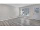 This spacious living area has gray laminate flooring and a door to the backyard at 3001 Will Rogers Se Pl, Atlanta, GA 30316