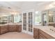 Spacious bathroom with double vanity, linen cabinets, and garden tub with views at 3590 Lester Sw Ct, Lilburn, GA 30047