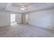 Large carpeted primary bedroom with tray ceiling, detailed trim, and a view into the bathroom at 3590 Lester Sw Ct, Lilburn, GA 30047