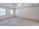 Spacious bedroom with neutral carpet, crown molding, a tray ceiling, and natural light at 3590 Lester Sw Ct, Lilburn, GA 30047