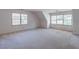 Spacious bedroom with natural light from multiple windows and neutral colored carpet flooring at 3590 Lester Sw Ct, Lilburn, GA 30047