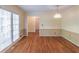 Bright dining room with hardwood floors, wainscoting, and a glass door leading to outdoor space at 3590 Lester Sw Ct, Lilburn, GA 30047