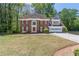 Beautiful two-story brick home with an attached garage and established landscaping at 3590 Lester Sw Ct, Lilburn, GA 30047