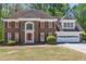 Charming two-story brick home featuring red shutters and a well-manicured lawn at 3590 Lester Sw Ct, Lilburn, GA 30047