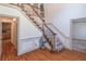 Elegant foyer with hardwood floors, a staircase, and decorative wainscoting at 3590 Lester Sw Ct, Lilburn, GA 30047