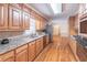 Traditional kitchen featuring granite countertops, stainless steel appliances, and wood cabinets and floors at 3590 Lester Sw Ct, Lilburn, GA 30047