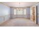 A formal living room featuring a bay window and an elegant chandelier at 3590 Lester Sw Ct, Lilburn, GA 30047