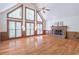 Spacious living room featuring a fireplace, hardwood floors, and large windows at 3590 Lester Sw Ct, Lilburn, GA 30047