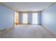 Bright living room with carpet, two windows, and views of other rooms at 3590 Lester Sw Ct, Lilburn, GA 30047