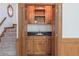 Cozy wet bar area nestled near the staircase with convenient sink and cabinet space at 3590 Lester Sw Ct, Lilburn, GA 30047