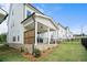 Landscaped backyard featuring a covered patio area, grass, and fence at 636 Silva St, Cumming, GA 30040