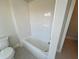 Bathroom with a toilet, tub, and tile flooring at 636 Silva St, Cumming, GA 30040