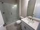 Modern bathroom featuring a glass shower, white vanity, and neutral color scheme at 636 Silva St, Cumming, GA 30040