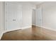 Bedroom featuring hardwood floors, closet, and neutral paint, creating a serene space at 636 Silva St, Cumming, GA 30040