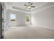 Bright bedroom with plush carpet, windows, and a ceiling fan at 636 Silva St, Cumming, GA 30040