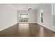 Bright, spacious bedroom featuring hardwood floors and sliding glass doors to balcony at 636 Silva St, Cumming, GA 30040