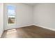 Bright bedroom with hardwood floors and a large window overlooking the backyard at 636 Silva St, Cumming, GA 30040