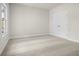 A carpeted bedroom with a window and a closet, offering ample storage and natural light at 636 Silva St, Cumming, GA 30040