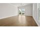 Sunlit bedroom featuring hardwood floors, a ceiling fan, and large windows at 636 Silva St, Cumming, GA 30040