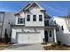 Charming two-story white home with a two-car garage and classic design at 636 Silva St, Cumming, GA 30040