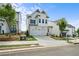 Charming home with white siding, landscaped front yard, and a long driveway with attached two-car garage at 636 Silva St, Cumming, GA 30040