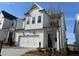 Beautiful two-story home with a white facade, garage, and professionally landscaped front yard at 636 Silva St, Cumming, GA 30040