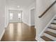 Hallway with hardwood floors leading to the living room and a staircase to the right at 636 Silva St, Cumming, GA 30040