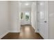Hallway featuring hardwood floors, neutral walls, and an exit to the exterior of the property at 636 Silva St, Cumming, GA 30040